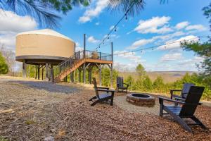 a group of benches sitting around a fire pit at Horizon Hideout - Modern Yurt in Brookville