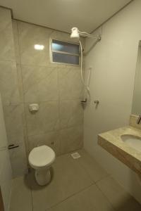 a bathroom with a toilet and a sink at Loft completo e climatizado a 2 minutos do centro in Cuiabá +121 photos