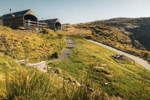 a house on the side of a hill with a path at Llechwedd Glamping in Blaenau-Ffestiniog