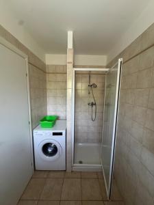 a bathroom with a washing machine and a washer at BIJOU in Conca +5 photos