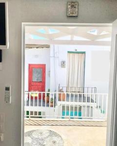 a view of a room with a red door at Cabarnus House in Parikia