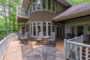 a deck with chairs and a table on a house at Amitola at Yonahlossee in Boone