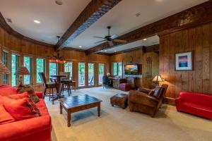 a living room with red furniture and a table at Amitola at Yonahlossee in Boone
