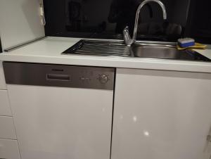 a kitchen with a sink and a stove at Apartman Centar comfort in Posušje +16 photos