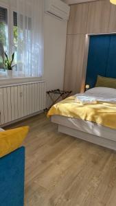 a bedroom with a large bed and a window at Studio apartma Rimljanka in Ptuj