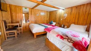 a bedroom with a bed and a desk and a chair at Kalinchowk Tripura Resort in Dhulikhel +7 photos