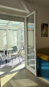 a room with a sliding glass door with a table and chairs at Studio apartma Rimljanka in Ptuj