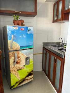 een koelkast met een afbeelding van een zeester en een gootsteen bij Apartamento con vista al laguito y al mar in Cartagena