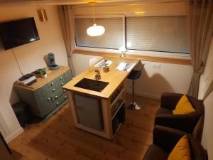 a small kitchen with a wooden island in a room at L'ANEDA Vue sur mer - COCCONING 2 Personnes - 3ème étage in Mers-les-Bains