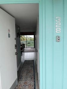 a hallway with a door leading to a dining room at Sunset Vista Condo 328 in Cedar Key +2 photos