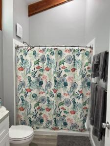 a bathroom with a shower curtain with birds on it at Sunset Vista Condo 328 in Cedar Key