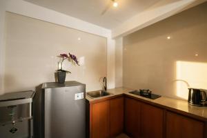 a kitchen with a stainless steel refrigerator and a sink at Kubu Daje Villa Canggu 2BR With Private Pool in Dalung