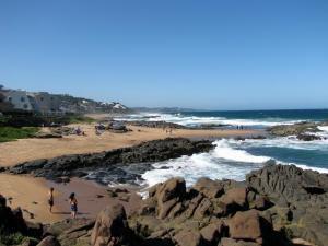 a group of people on a beach near the ocean at 7 Vallen Lodge in Ballito