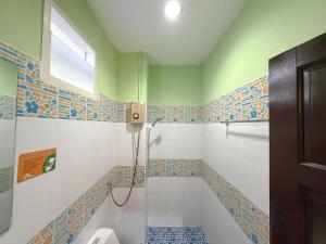 a bathroom with a toilet and a window at Chongkhao Resort- Phi Phi Island in Phi Phi Don +83 photos