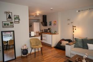 Una sala de estar con un sofá y una cocina. en Cozy Penthouse Private Balcony City Centre, en Stavanger