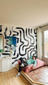 a man and a woman laying on a bed in a room at #Le80ies - Downtown Rooftop - Free shuttle to ski Mountain in Mont-Tremblant