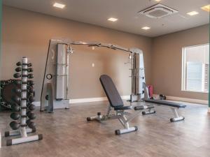 a gym with two tread machines in a room at Olimpia Park Resort in Olímpia