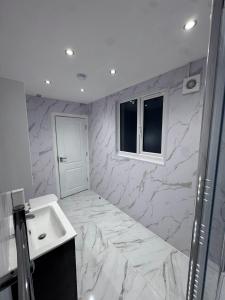 a bathroom with a sink and a marble wall at The Albion Hotel in Hull