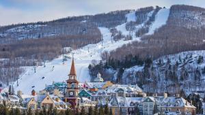 a town in the snow with a ski slope at #Le80ies - Downtown Rooftop - Free shuttle to ski Mountain in Mont-Tremblant