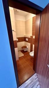 a view of a bathroom with a toilet and a door at Penzion Ranch in Hořovice +14 photos