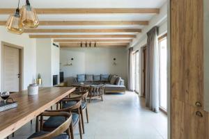 a living room with a table and a couch at Upper View Villa, with private pool in Chania
