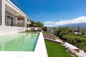 a swimming pool in the backyard of a house at Upper View Villa, with private pool in Chania