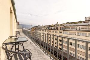 a balcony with a table and chairs and buildings at Cityview Balcony - in the heart of Biel in Biel