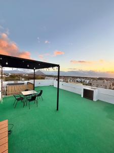 a balcony with green flooring and a table and chairs at Mont Oreb Villas Ambre Flic en Flac in Midlands Station +19 photos
