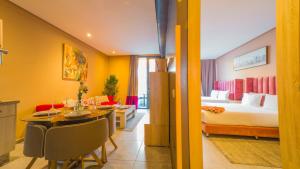 a hotel room with a bed and a dining room at Atlas-Résidence by Rent-Inn in Rabat +60 photos