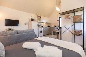 a living room with a couch and a kitchen at Casa Serafina by Rent-a-key in Santa Maria Madalena +14 photos