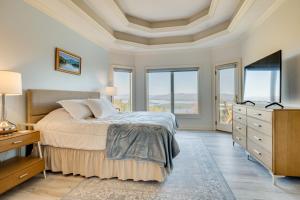 a bedroom with a bed and a dresser and windows at Million-Dollar Mtn Views! Gilford Gilded Loon in Glendale