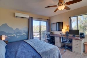 a bedroom with a bed and a desk with a computer at Pool and Stunning Mtn Views! Eclectic Tucson Home in Tucson