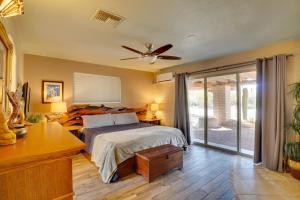 a bedroom with a bed and a ceiling fan at Pool and Stunning Mtn Views! Eclectic Tucson Home in Tucson +27 photos