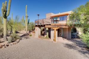 a house in the desert with a palm tree at Pool and Stunning Mtn Views! Eclectic Tucson Home in Tucson