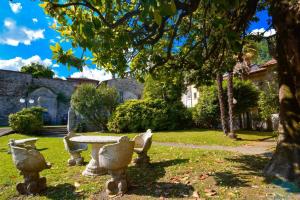 a park with a stone table and a tree at Timeless Garden Lake Como in Gravedona