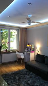 a living room with a couch and a ceiling at A3XD Apartament in Częstochowa