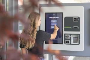 a woman is standing in front of an atm machine at Hotel Felix in Niederdorla
