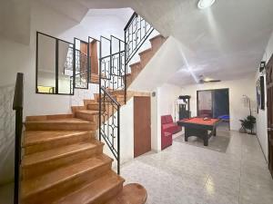 a staircase in a house with a ping pong table at Alojamiento para 3 personas con alberca y billar in Chuburná de Hidalgo