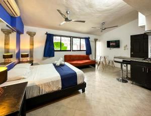 a bedroom with a bed and a couch and a piano at Alojamiento para 3 personas con alberca y billar in Chuburná de Hidalgo +11 photos