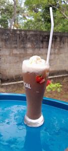 a drink with a straw sitting on top of a table at Villa Koratuwa in Ahangama