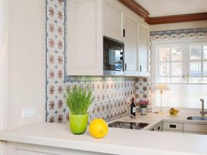 a kitchen with a counter with a vase with a plant at Rasmus-5 in Kampen +6 photos