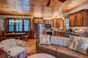 a living room with a couch and a kitchen at Rivers Edge at Eagles Nest in Banner Elk