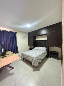 a bedroom with a bed and a desk and a table at Don Charlie in Veracruz +7 photos