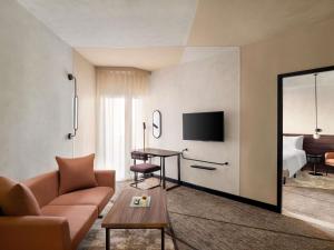 a living room with a couch and a table at Novotel Cairo 6th Of October in 6th Of October +75 photos