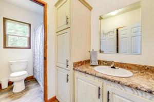 a bathroom with a sink and a toilet and a mirror at House on Oneida Lake on Lewis Point in Canastota in Canastota +30 photos