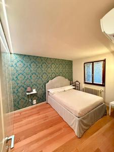 Postel nebo postele na pokoji v ubytování Palazzo Foresi by Strozzi 120m Luxury Apartment