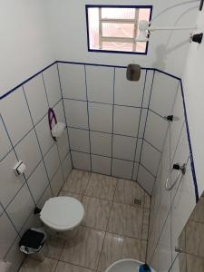 a small bathroom with a toilet and a window at Air conditioning, TV and free parking - Bathroom in Cuiabá +2 photos