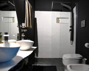 a bathroom with two sinks and a toilet and a shower at Appartamenti "UNIQUE" palazzo storico FAENZA in Faenza +22 photos
