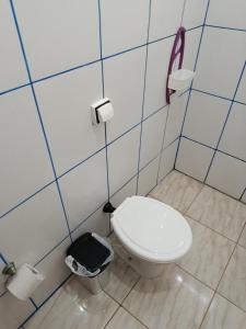 a bathroom with a toilet and a phone on the wall at Air conditioning, TV and free parking - Bathroom in Cuiabá