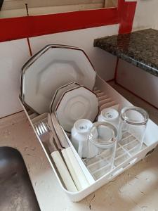 a white tray with utensils in a kitchen sink at Air conditioning, TV and free parking - Bathroom in Cuiabá